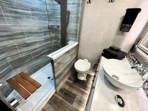 The bathroom is an inviting space with its walk-in shower and upscale fixtures.