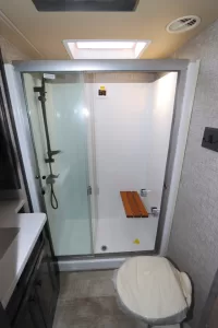 The 48-inch-by-30-inch shower comes with a glass enclosure and a fold-down teak seat.