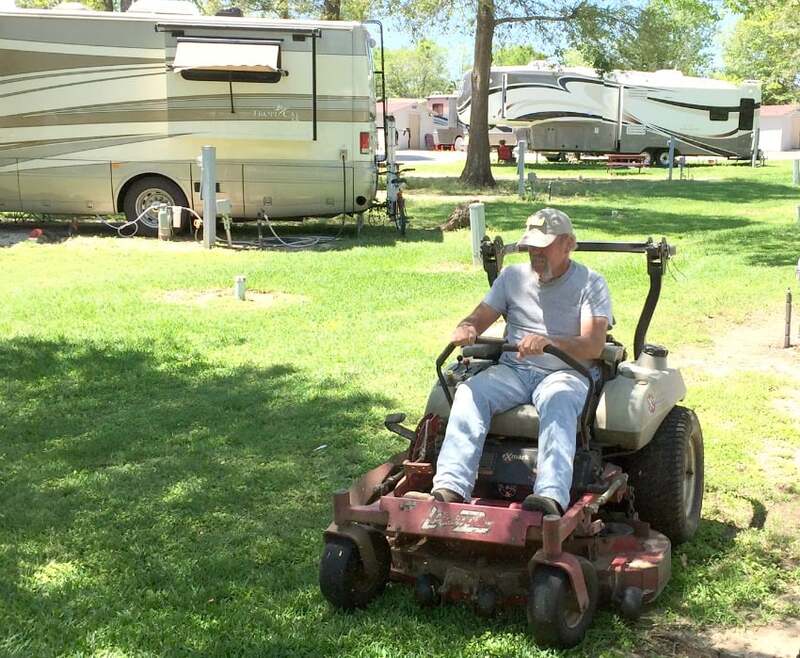 guy on mower in campground