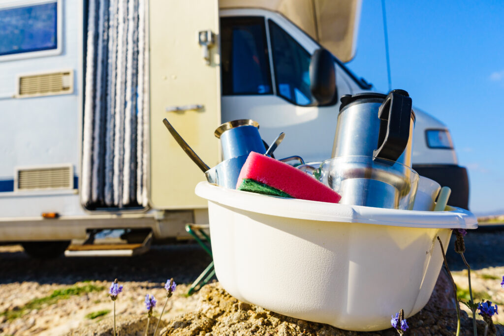dishes in front of RV for conserving water