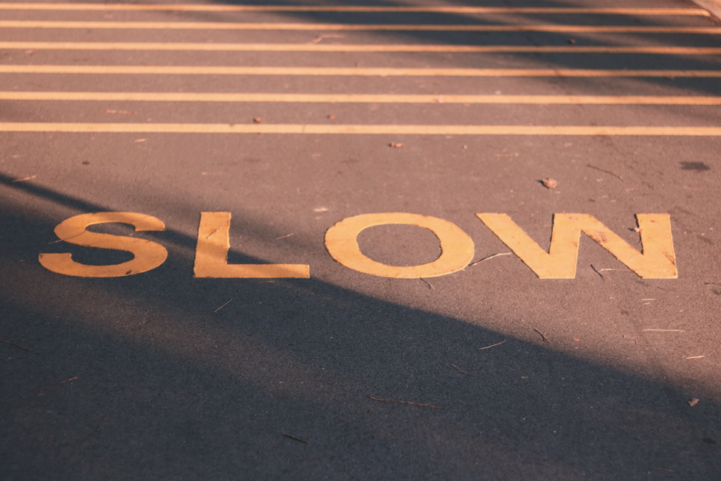 “Slow” sign on road