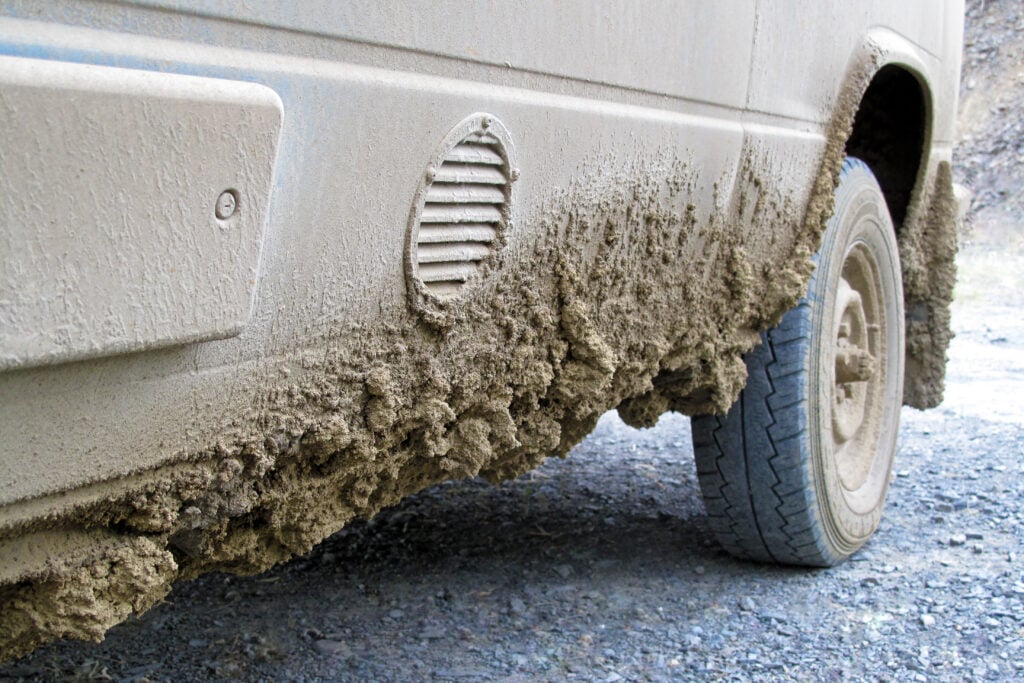 mud on side of RV, feature image for how to get unstuck from mud in an RV