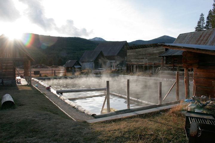a steamy hot spring at a farm at sunrise