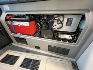 A rear compartment houses electrical items, including the lithium-ion battery.
