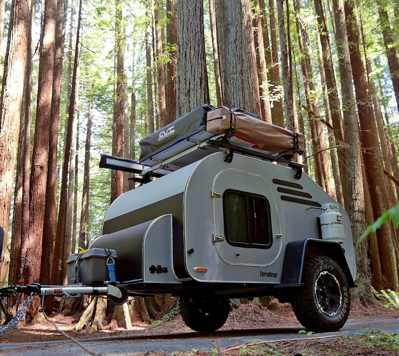 The Terradrop all terrain trailer equipped with a rooftop tent being towed through the forest