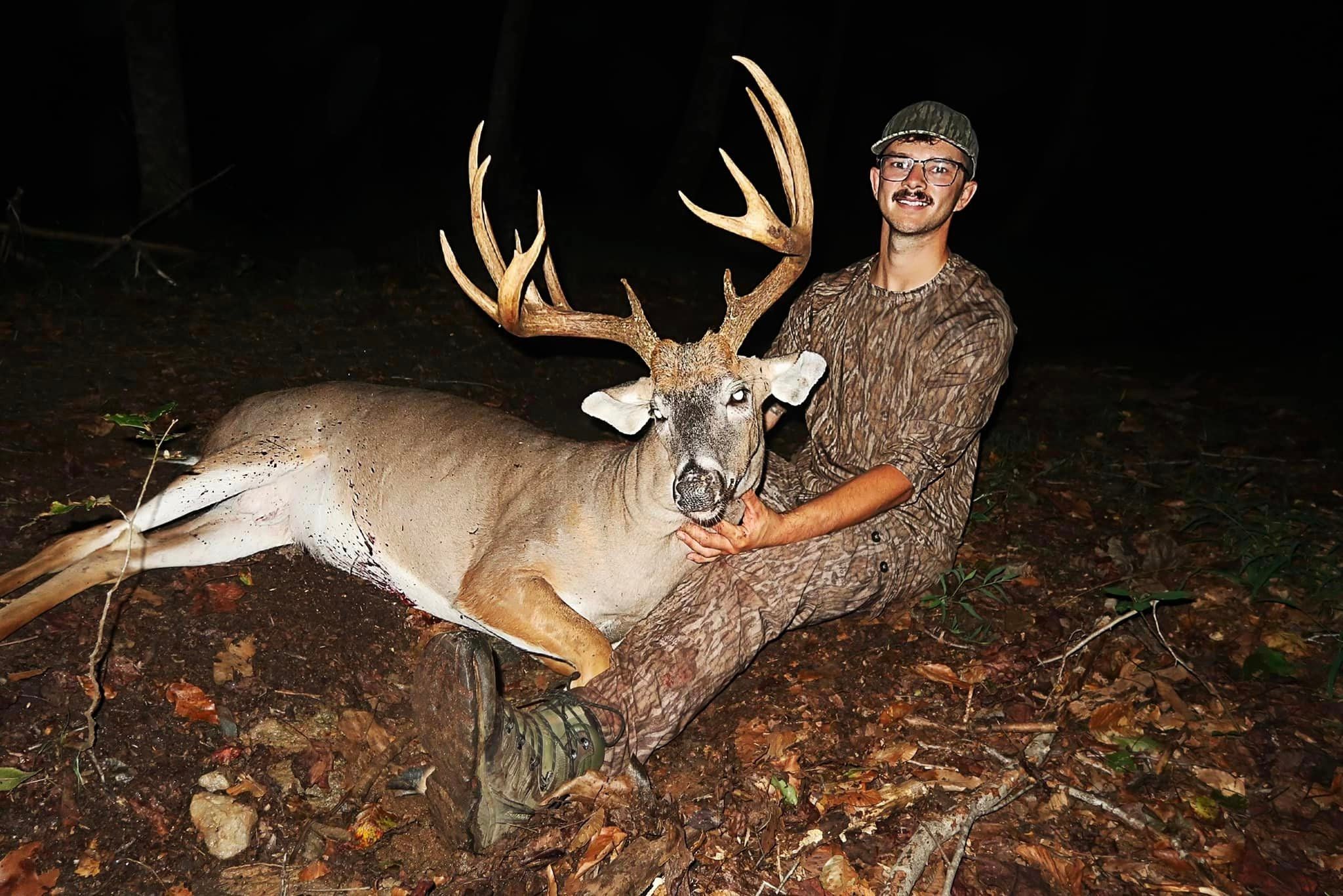 A bowhunter holds up the head of a big North Carolina buck.