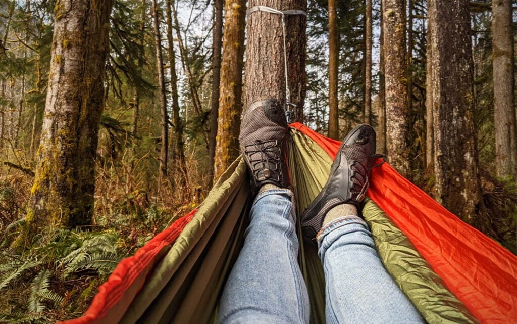 The author lounging in the ENO DoubleNest using the ENO Helios suspension straps. 