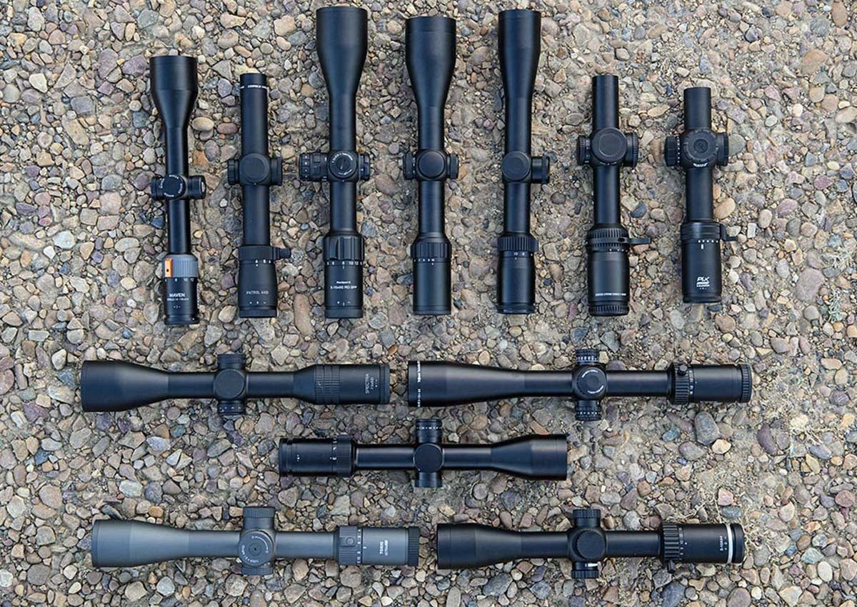 The best rifle scopes for deer hunting laid out on rocks.