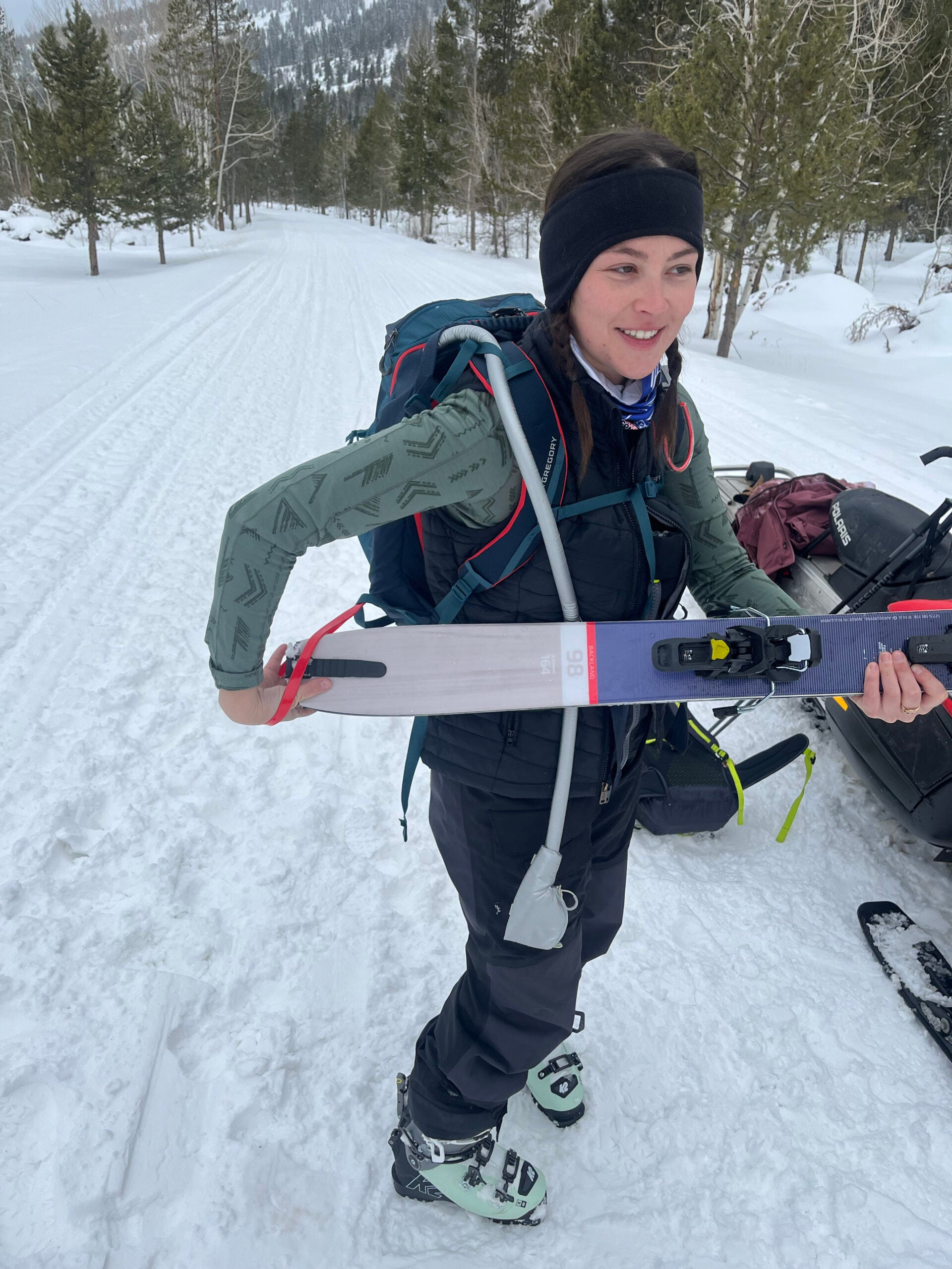 Insert back of skis into the red carry loop on the bottom right side of the Targhee.