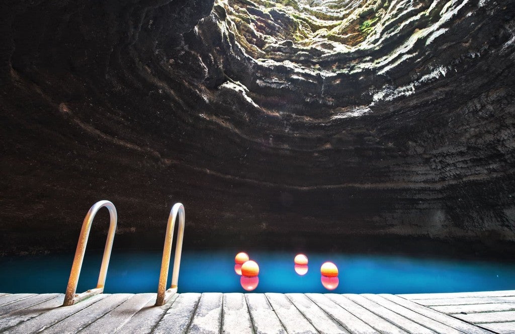 the swimming deck at the bottom of the cavern next to the blue water of homestead crater hot springs near salt lake city
