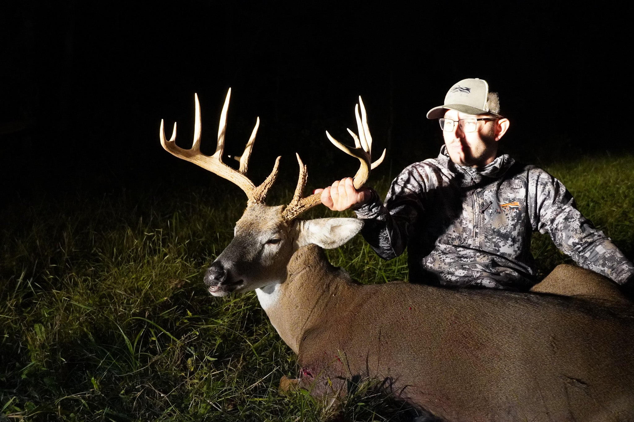 A big Ohio buck illuminated by truck headlights.