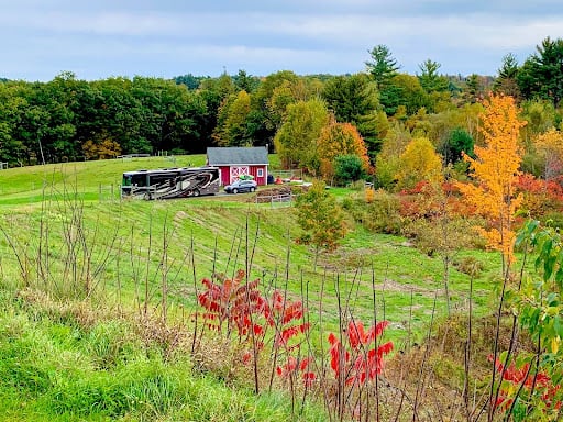 Farm property in the fall with Class A motorhome parked near barn.