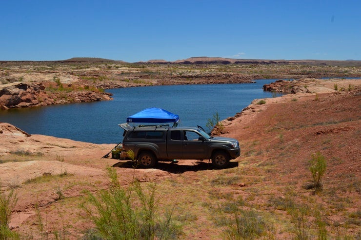 truck overlooking desert river on a planned camping trip