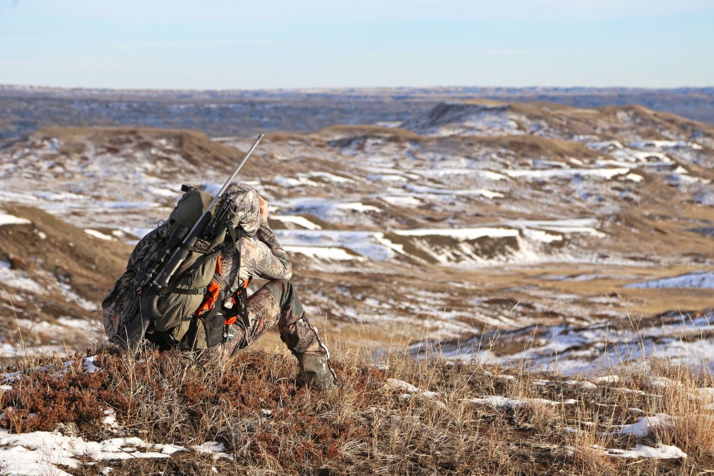 Hunter glasses a hillside.