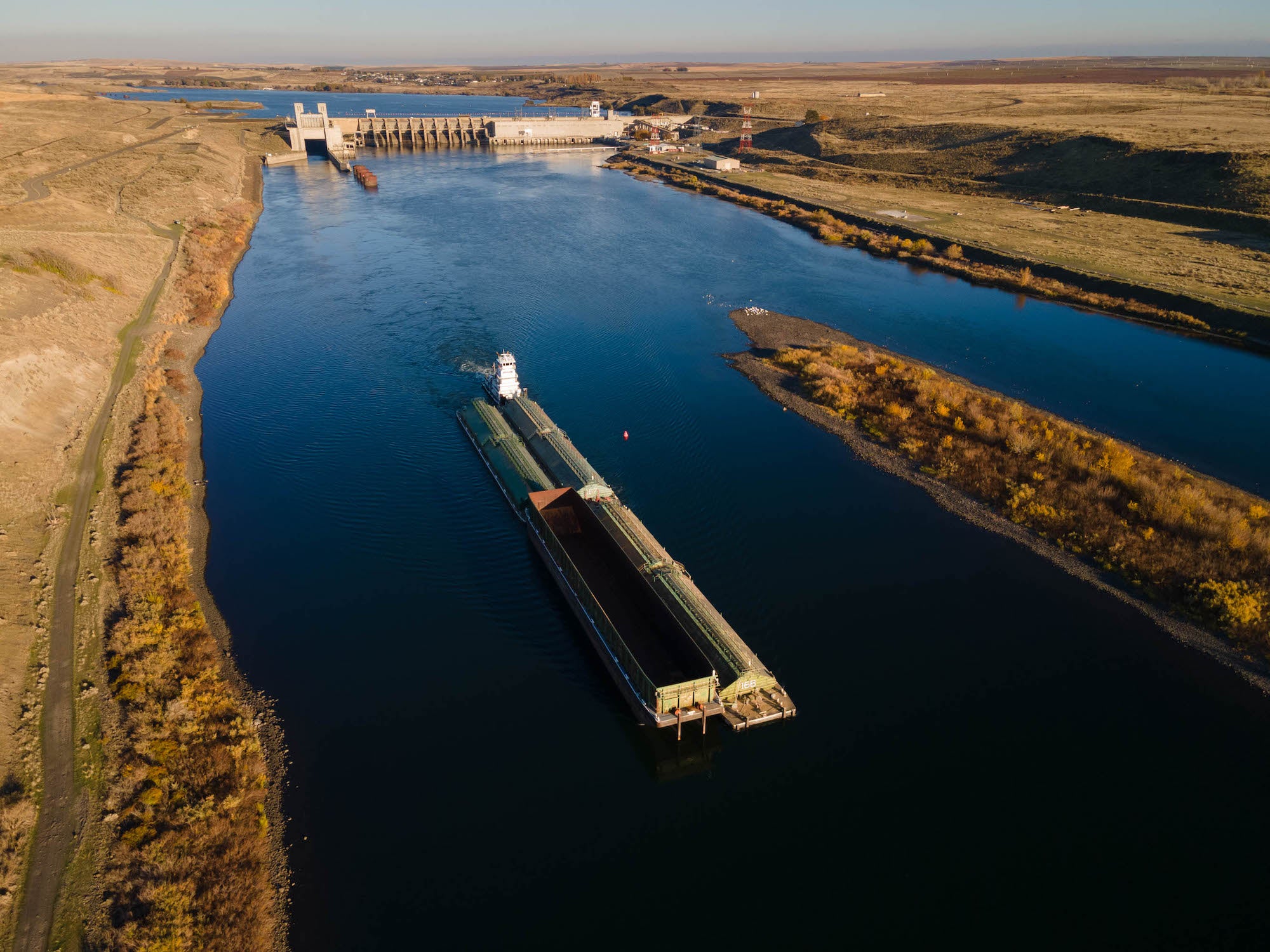 The construction of the Lower Four Snake River Dams made Lewiston, Idaho the furthest inland port in the United States. The lower river is now used by barges, which carry everything from winter wheat to baby steelhead.