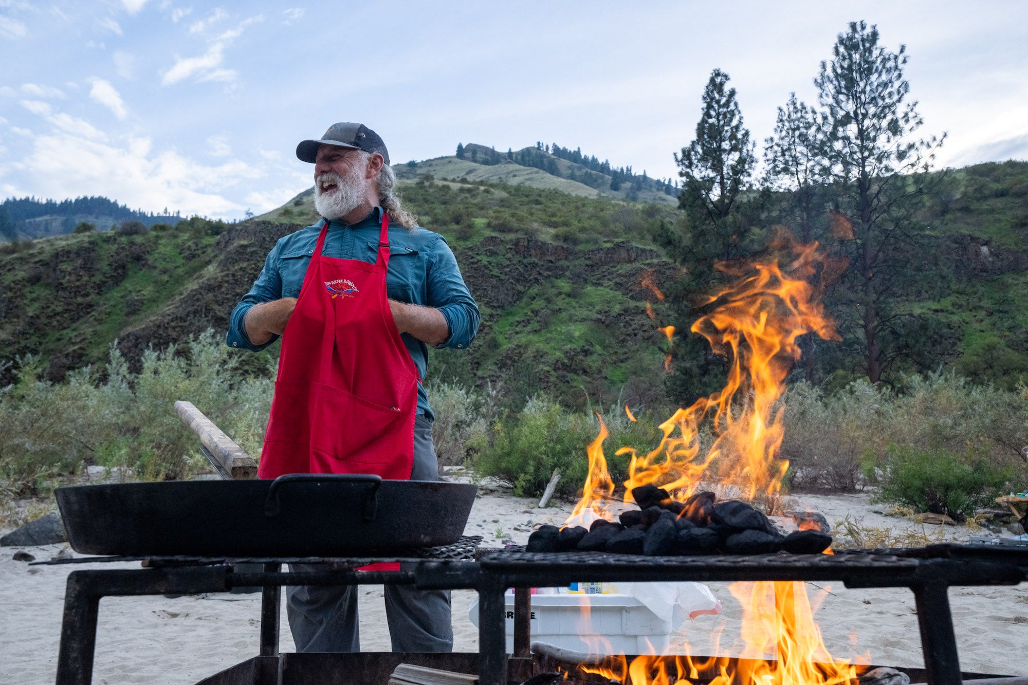 The owner of Rapid River Outfitters and the leader of our trip, Roy Akins cooks dinner over an open fire.