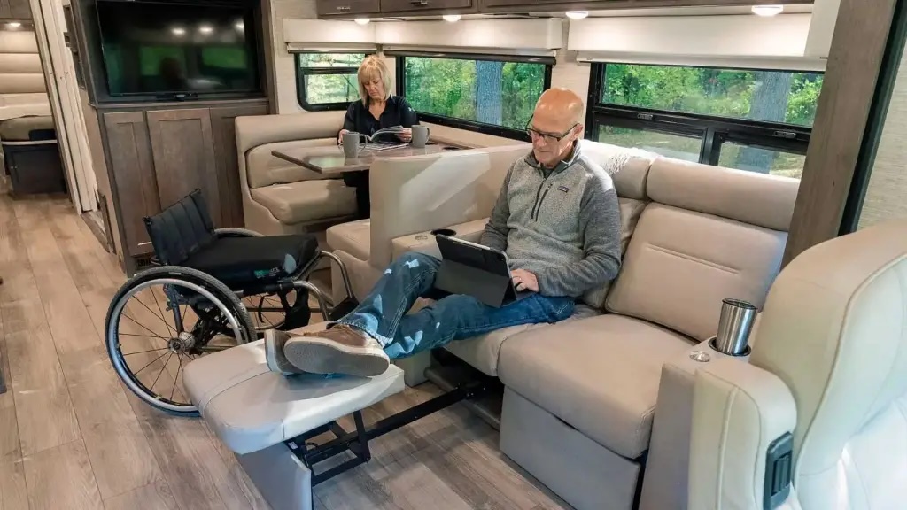 Couple sitting in a Class A RV with a wheelchair between them