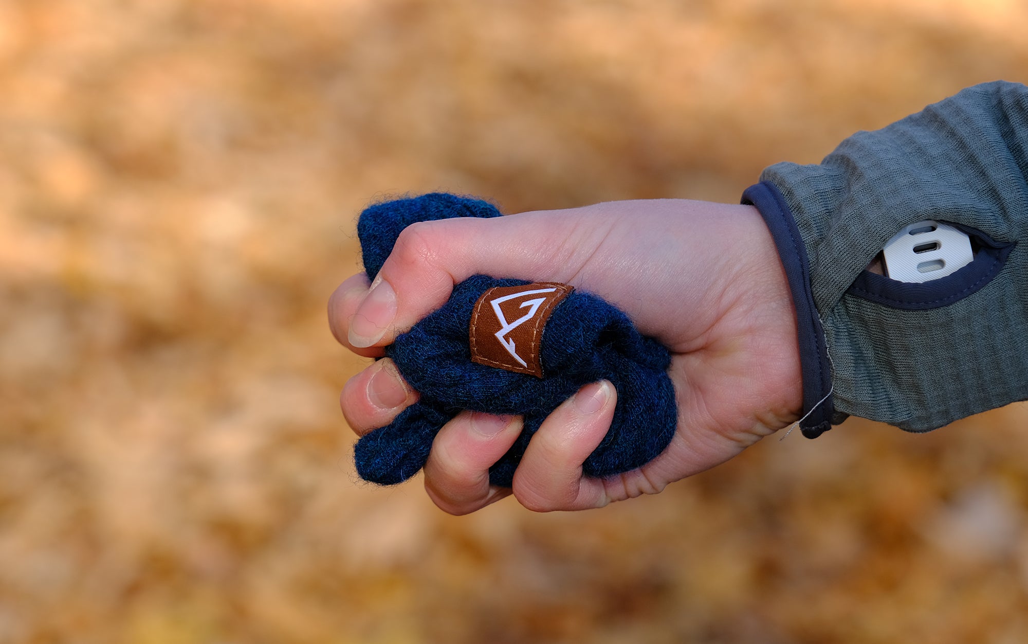 Author holds All-Paca Fleece Beanie in fist.