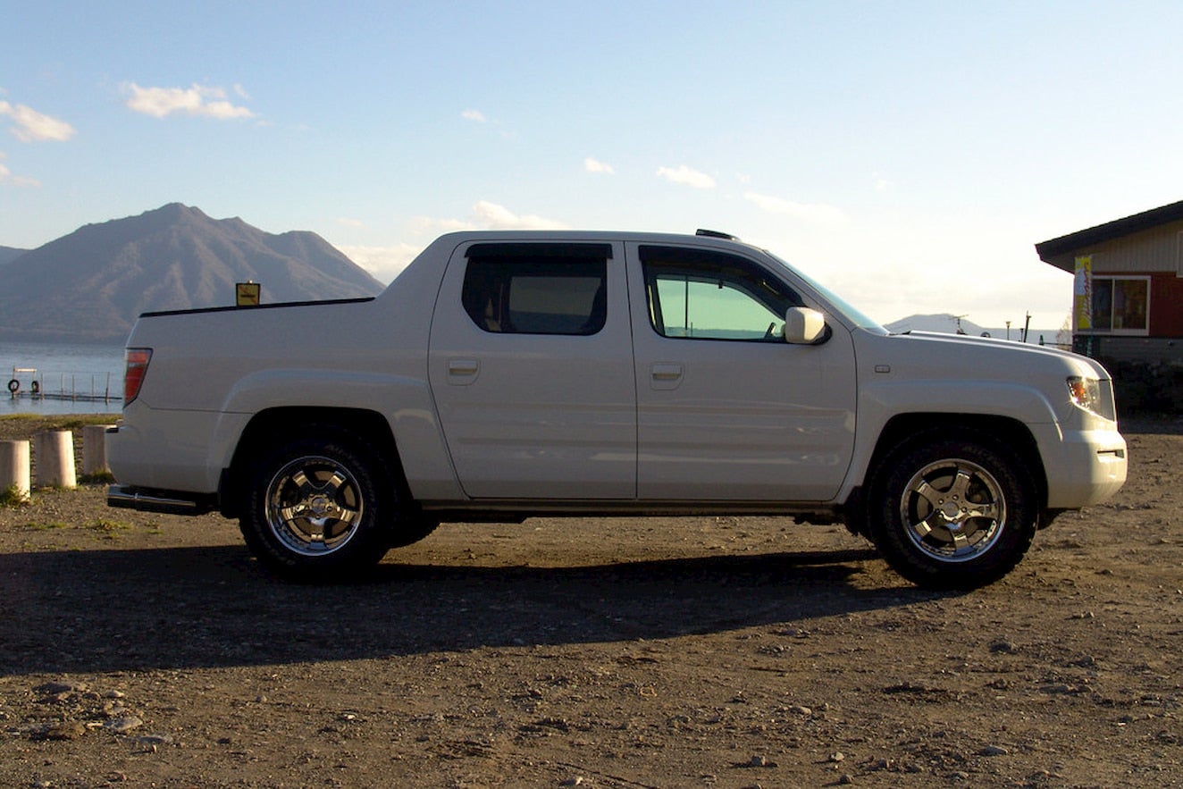 Honda Ridgeline parked in mountain desert landscape.
