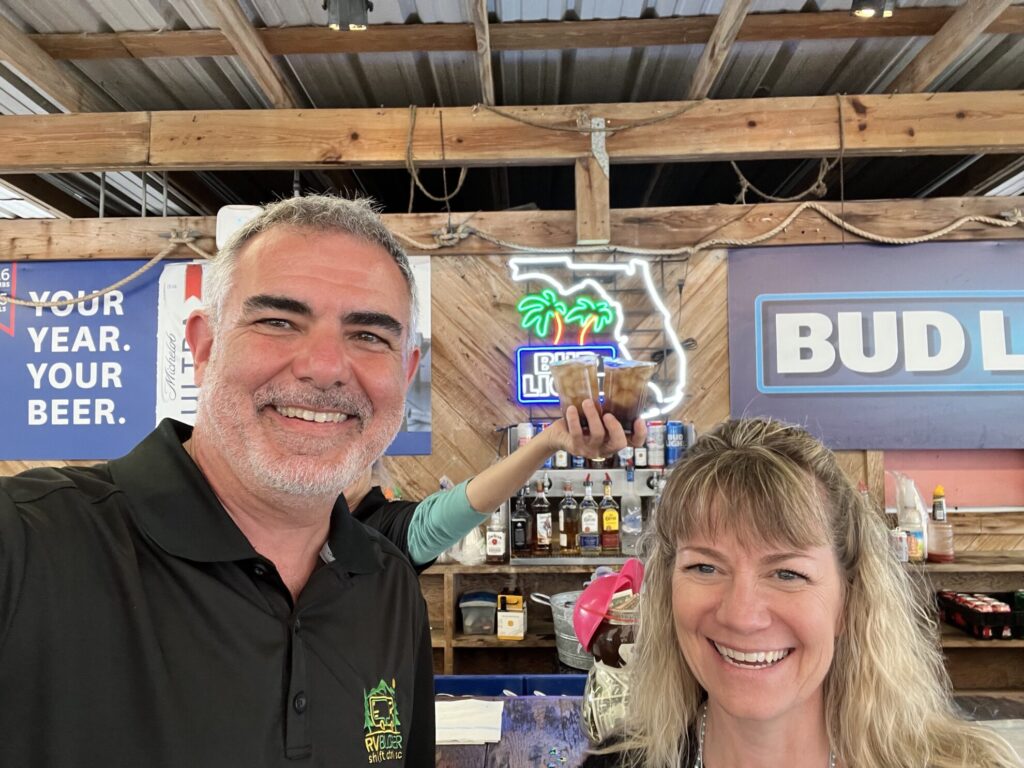 Mike and Susan celebrating at Tampa RV Show at an outside bar
