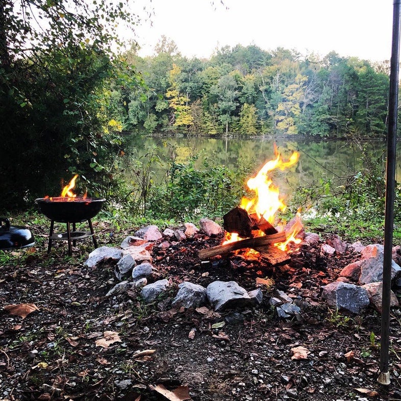 a fire burns in a fire pit at a primitive campground