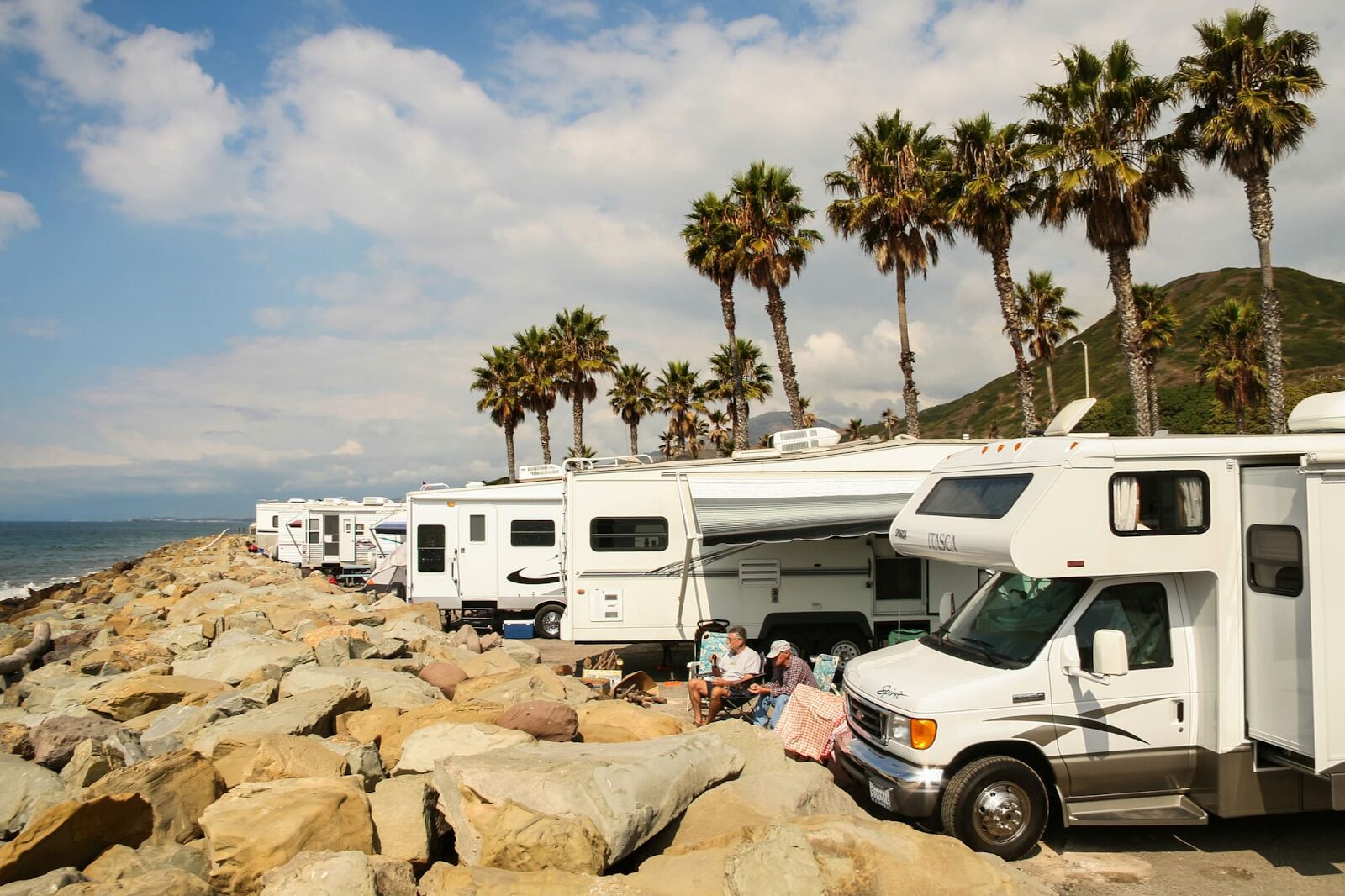RVs parked along the ocean with palm trees - snowbird rental