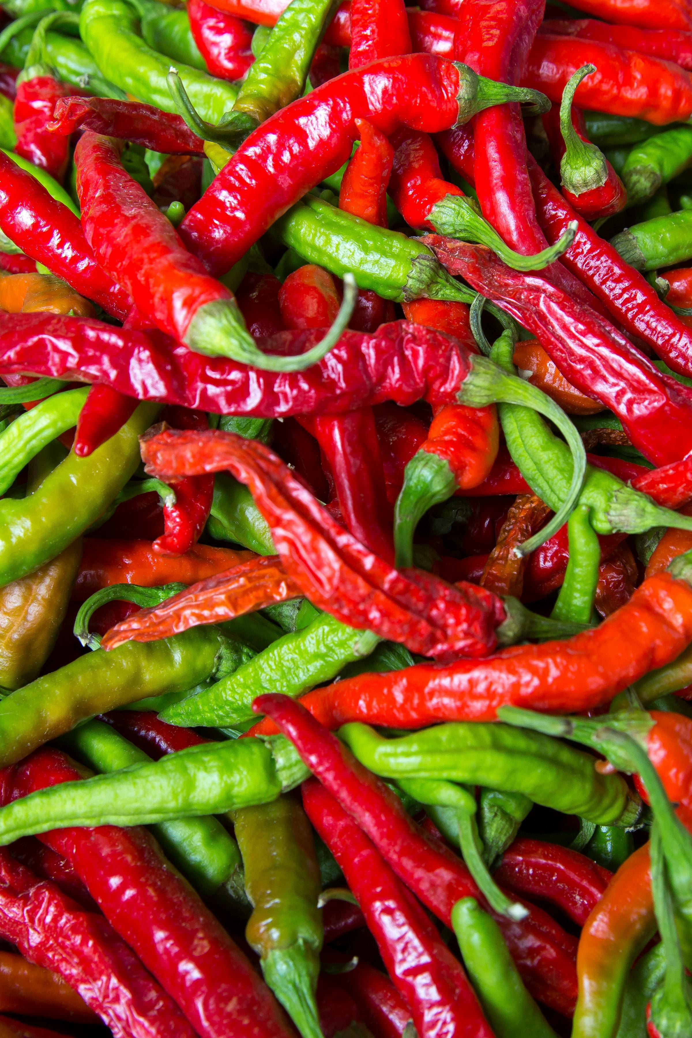 Red and green chili peppers - Photo by Mark Stebnicki: https://www.pexels.com/photo/pile-of-red-and-green-chili-peppers-2893882/
