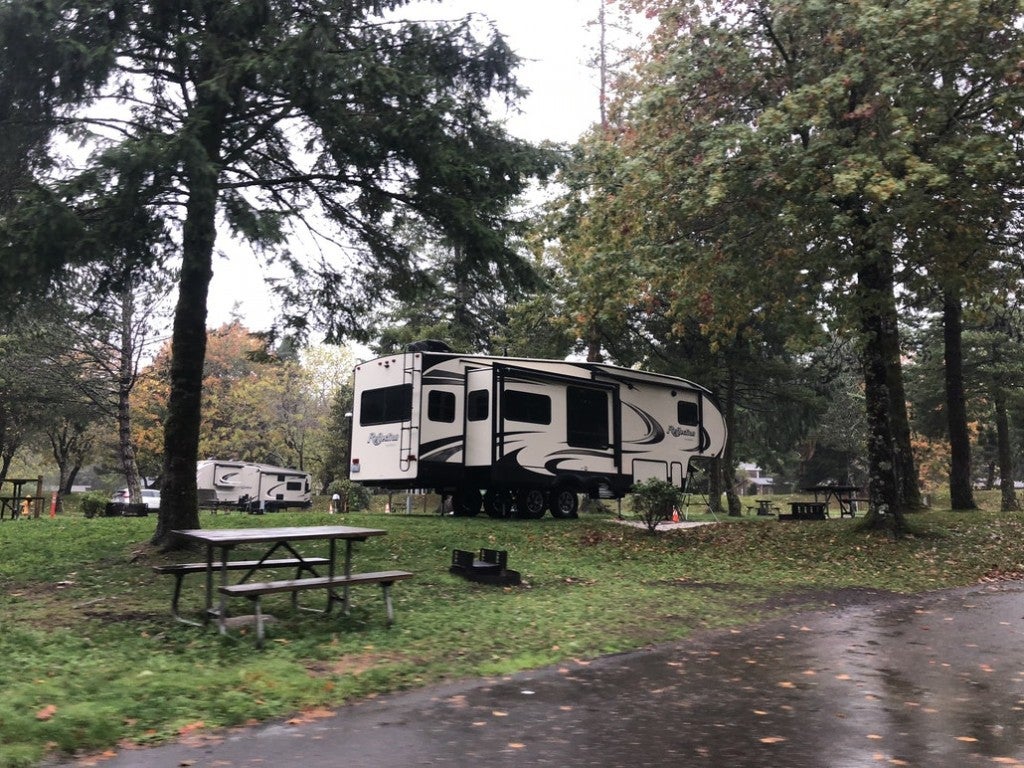 an RV parked in a campsite in the woods