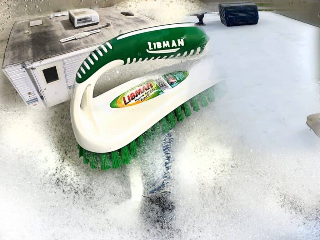 A brush and soapy water on an RV roof while RV spring cleaning. Image: Bruce W. Smith