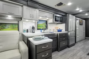 The 38RB’s galley, here with the Volero décor package and optional Asheville cabinetry, features contemporary residential styling.