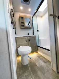 A nice-size rear bathroom closes off with a pocket door for privacy.