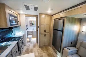 The galley has a farm-style sink, three-burner range, and 11-cubic-foot fridge.