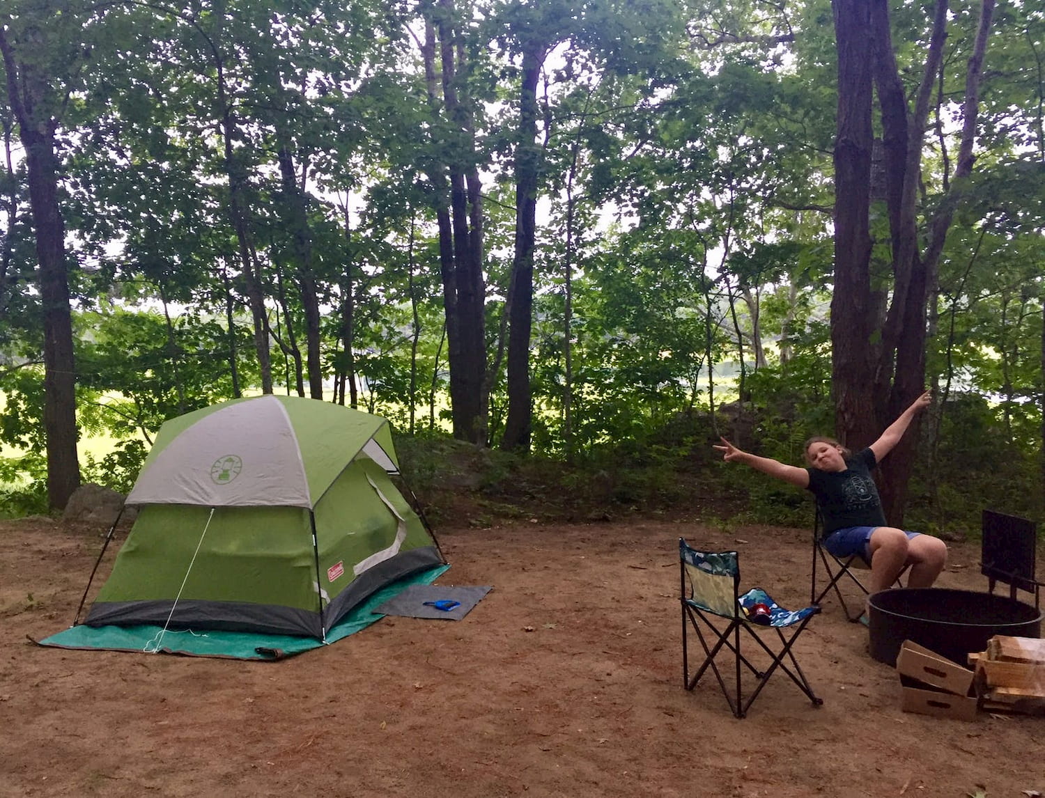 tent and chairs around campfire ring