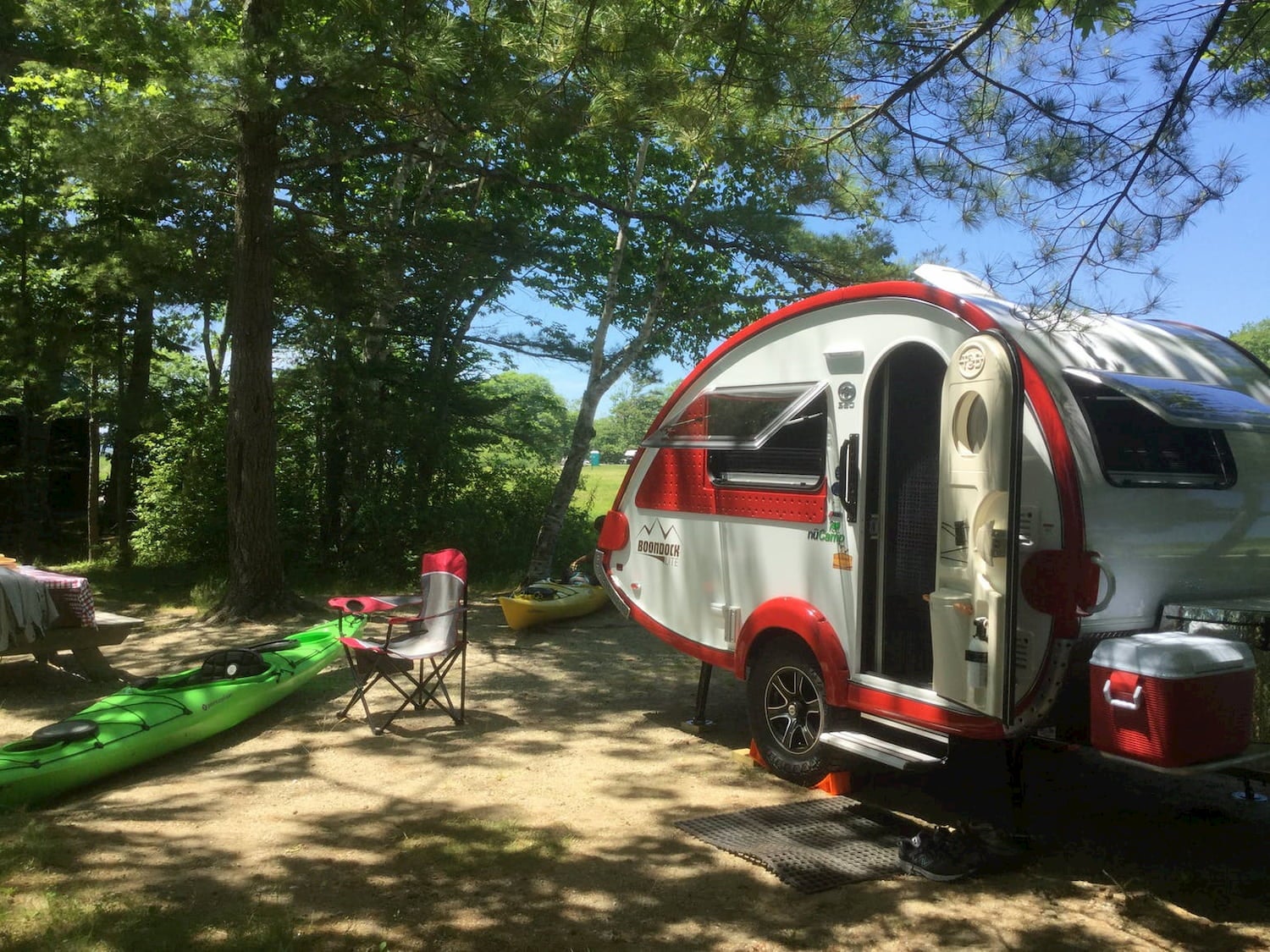 teardrop trailer and kayaks at campsite