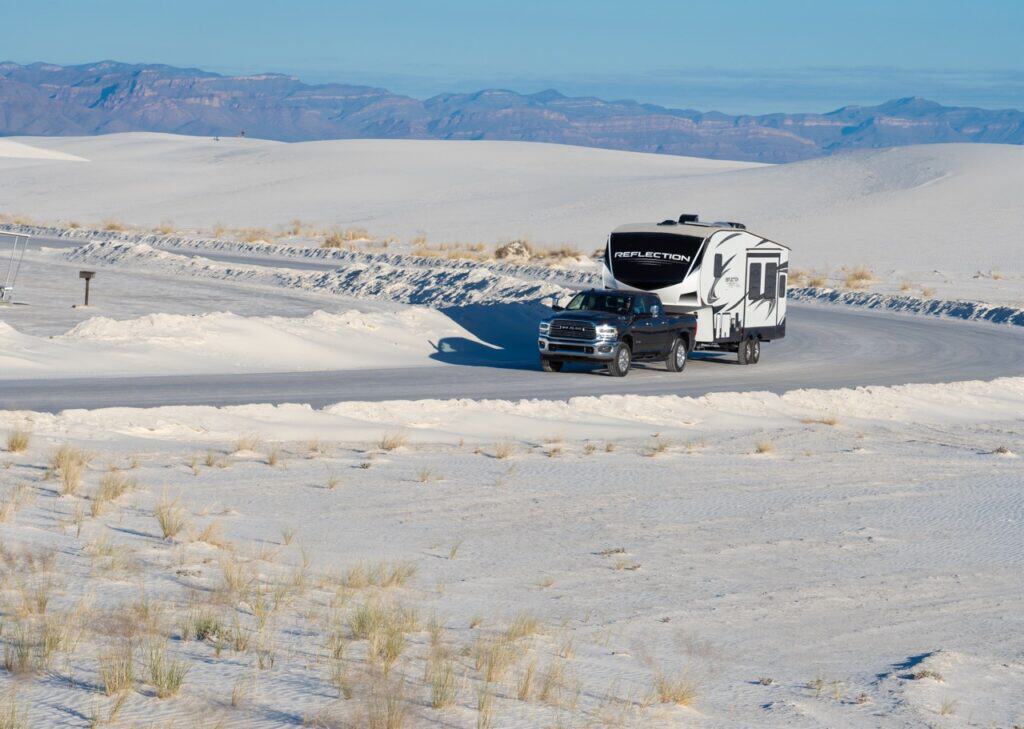 A truck with an auxiliary fuel tank towing a fifth-wheel in a barren desert. Photo: Bruce Smith.