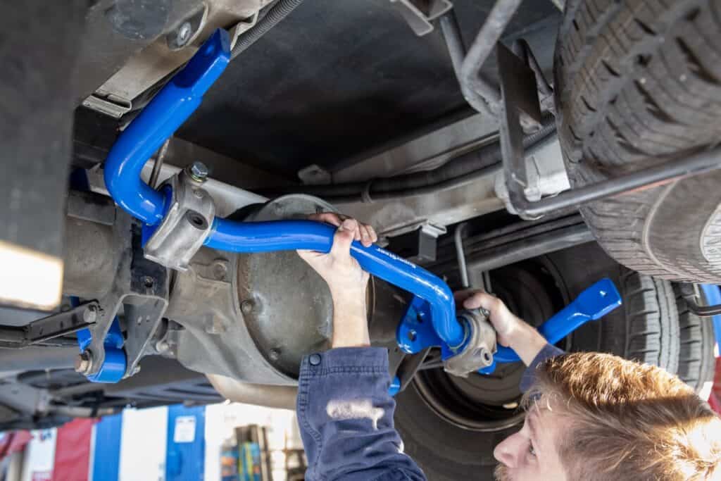 An RV technician installing an RV sway bar. Photo: Bruce Smith.