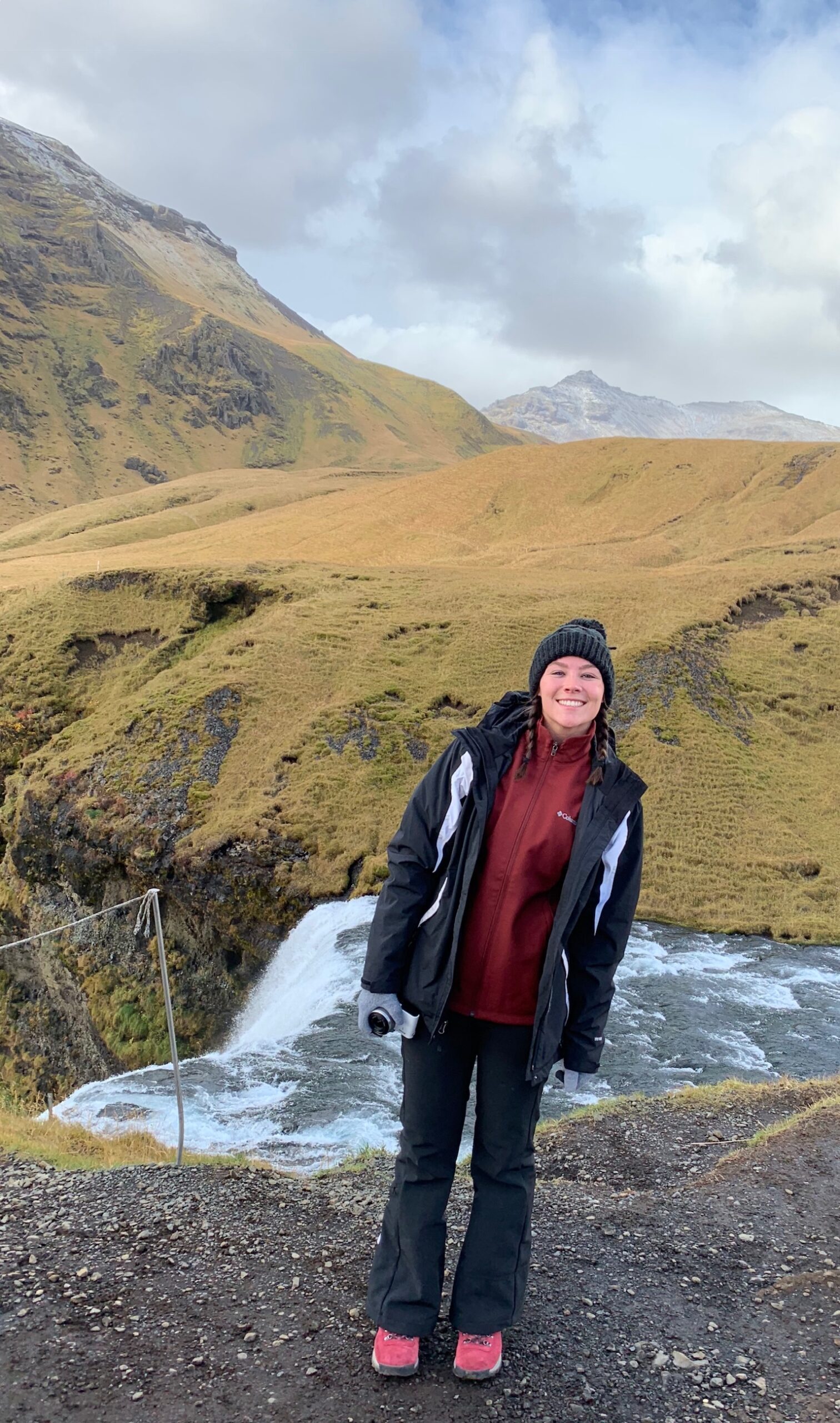 Author stands at top of waterfall in one of the best hiking shoes for beginners.