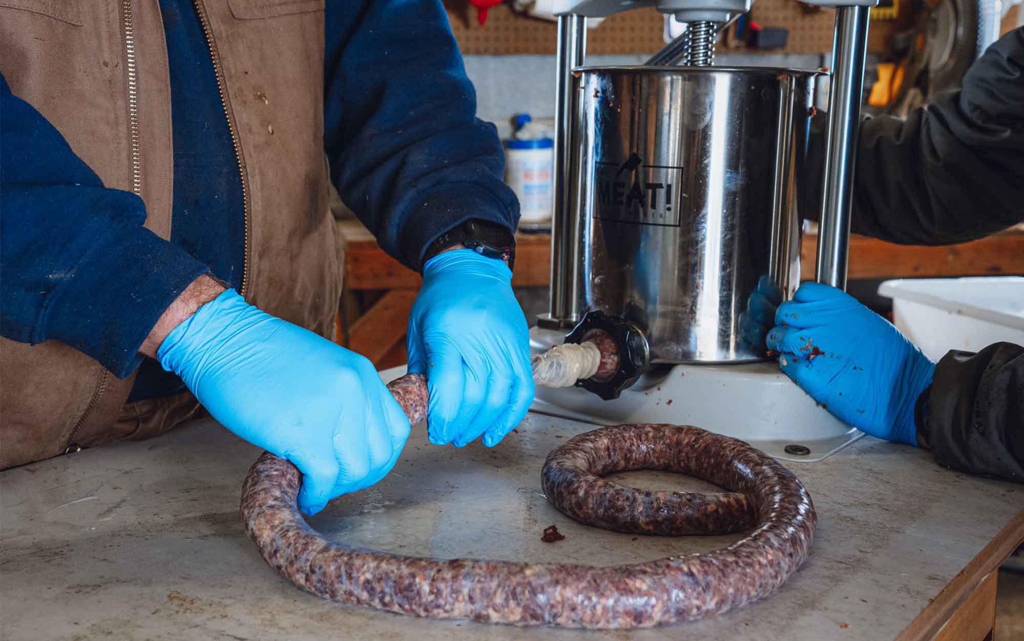 Processors test the Meat! sausage stuffer.