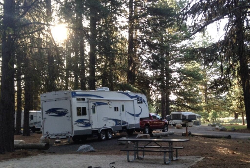 A truck and fifth-wheel in a campsite at Ponderosa State Park.