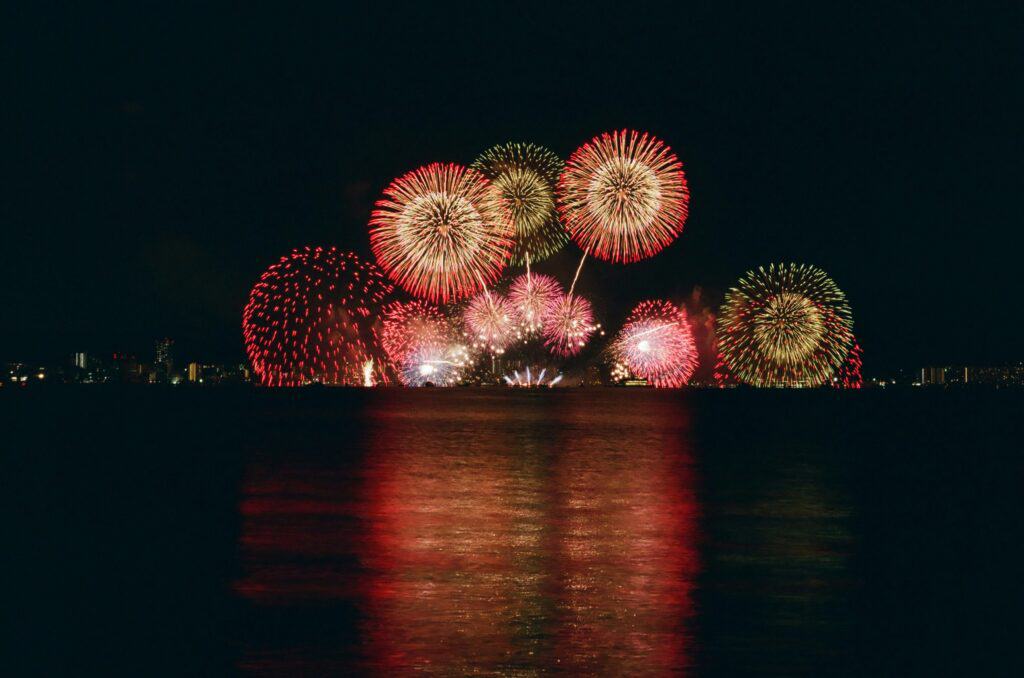 A Fourth of July fireworks display out over water.