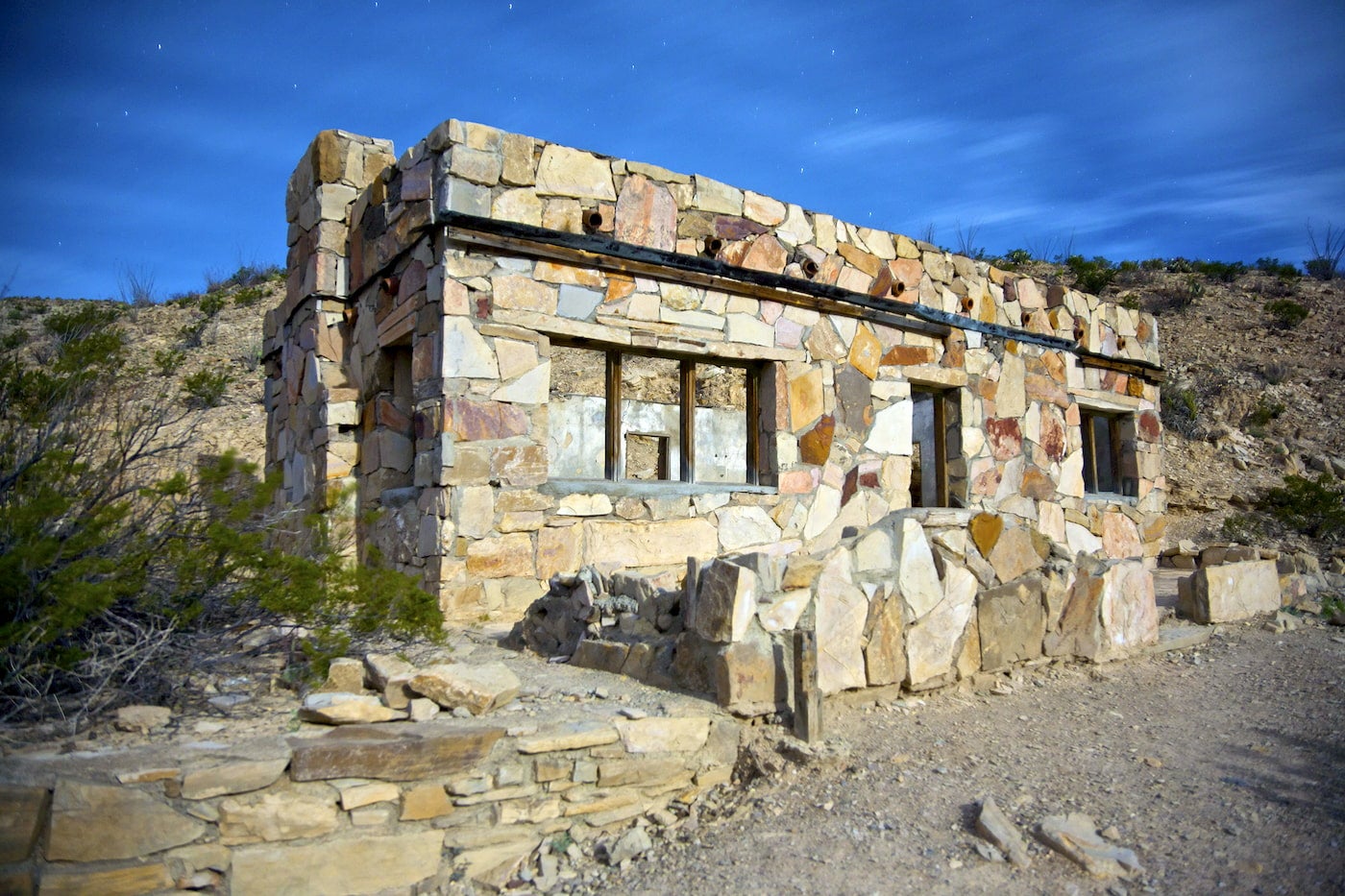 Stone building in the desert with hollow windows.