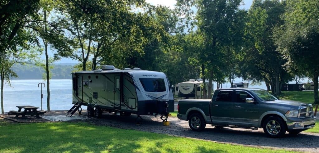 A truck and trailer in an RV site at Defeated Creek Park, one of our top budget campgrounds.