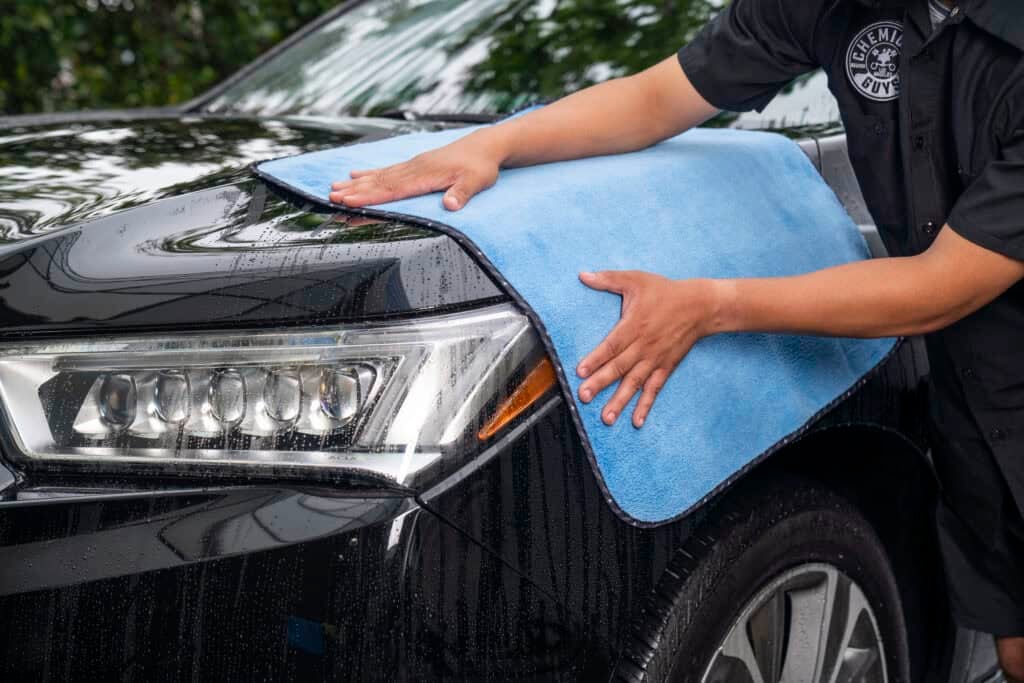 Man dries vehicle with the Thirst Trap towel from Chemical Guys
