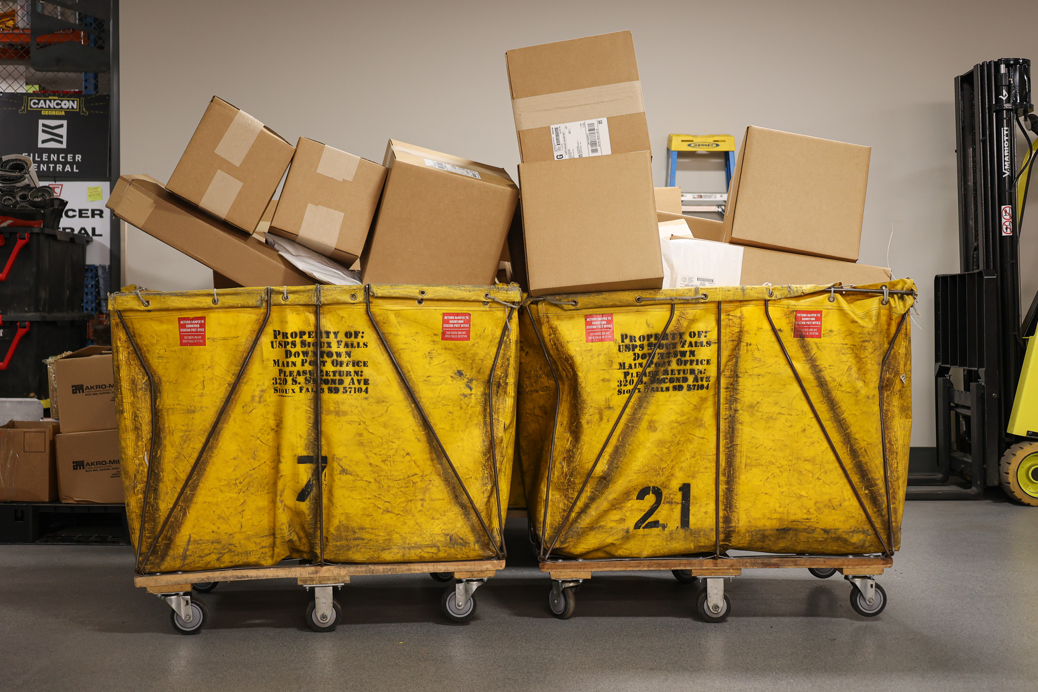 Boxes in yellow mail hoppers.