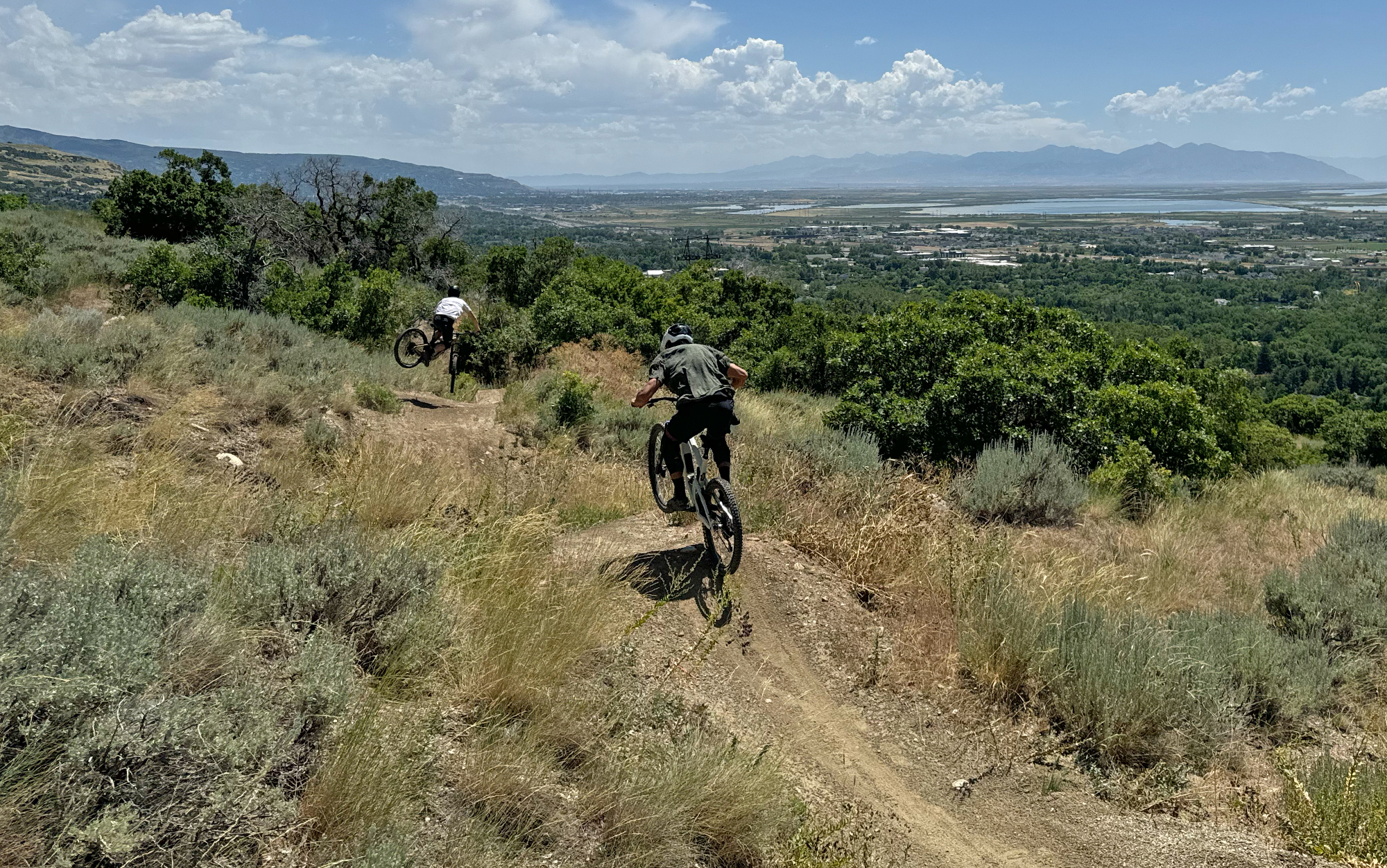 Two bikers hit a jump line.