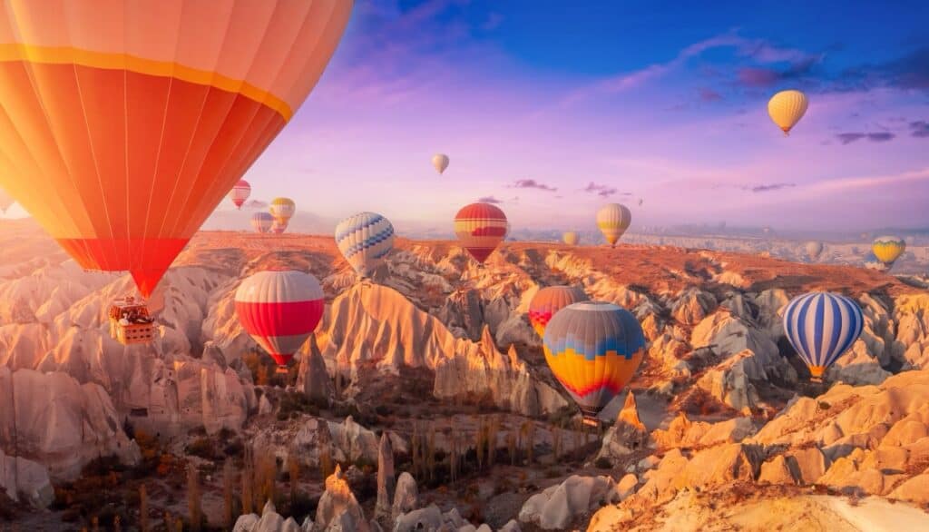 Hot-air balloons traveling over canyonlands. Photo: Shutterstock.