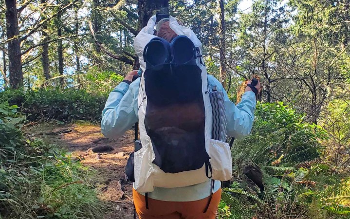  woman hiking through forest with the crop on the OV CS40 backpack