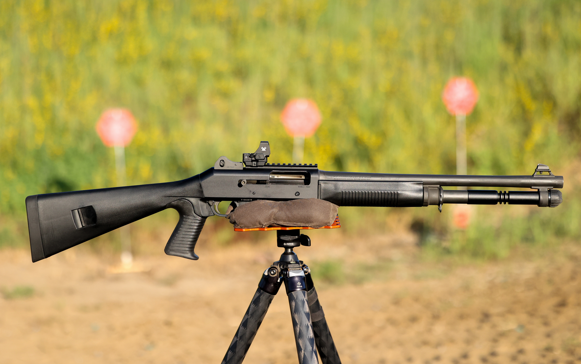  The Benelli M4 home defense shotgun on a tripod at the range.