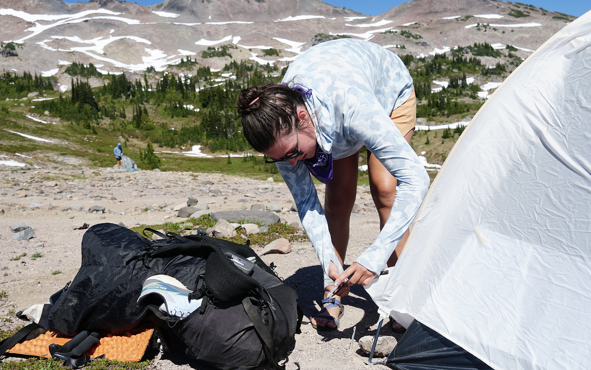 Woman setting up the Mountain Hardwear Nimbus on hard ground