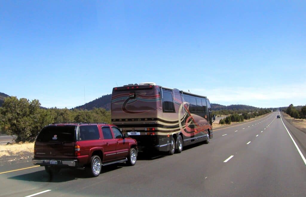 A motorhome dinghy-towing an SUV.